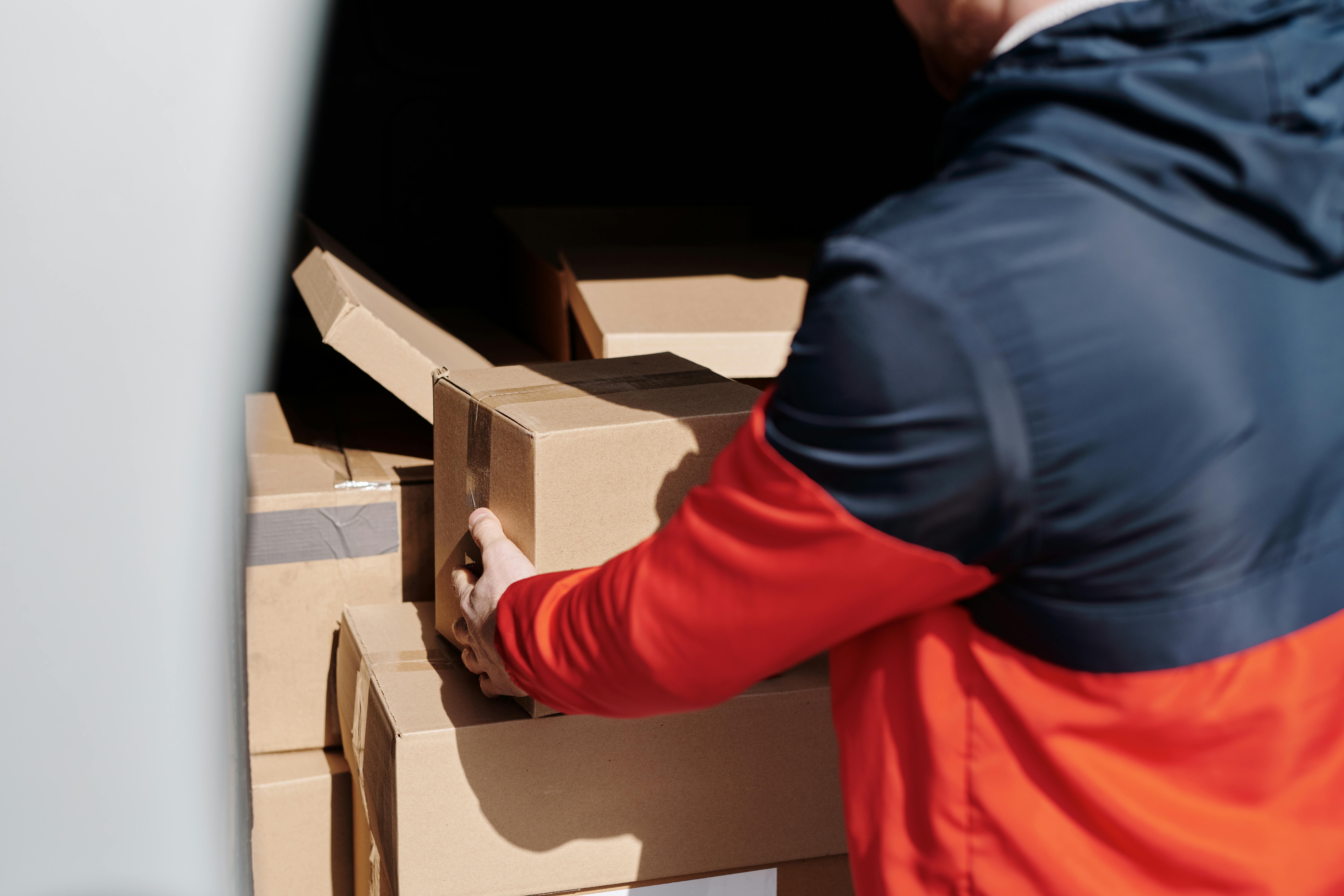 A person holding a cardboard box | Source: Pexels